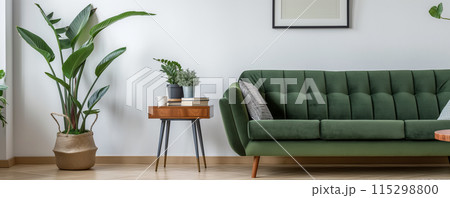 Minimalist living room with a clean and cozy aesthetic, featuring a green fabric sofa 115298800