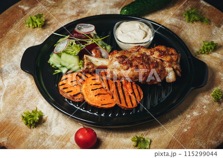 A Culinary Masterpiece: Chicken, Sweet Potatoes, and Vegetables on a Plate 115299044