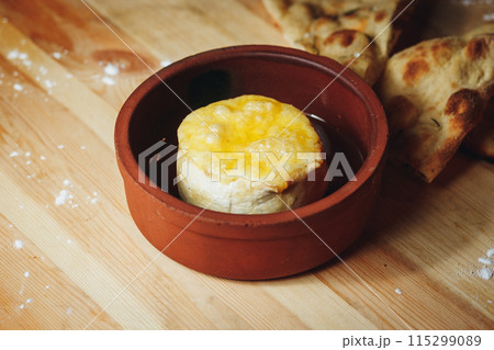 A Gourmet Delight: Cheese Bowl on Wooden Table 115299089