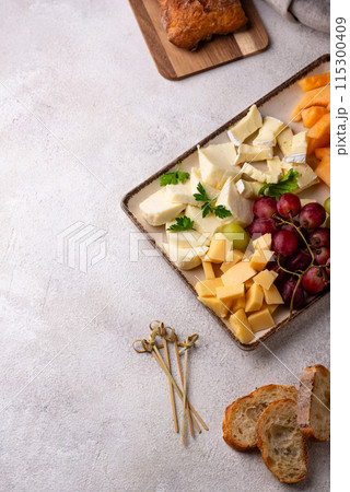Cheese plate with different cheese, grapes and melon. Cheese plate with different cheese, grapes and melon. 115300409