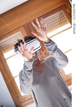 Young black woman testing a virual reality device. 115300706