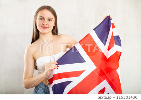 Young woman with UK flag posing in studio Young woman with UK flag posing in studio 115301430