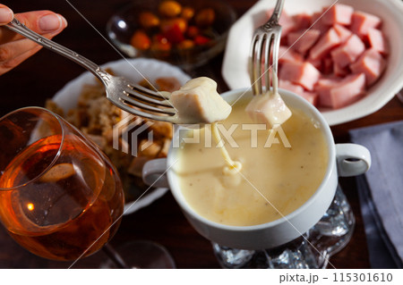 Cheese fondue with bread and snacks 115301610