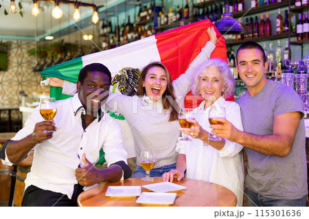 Emotional multiracial man and woman spots supporters with flag of Mexico happy about victory in championship Emotional multiracial man and woman spots supporters with flag of Mexico happy about victory in championship 115301636