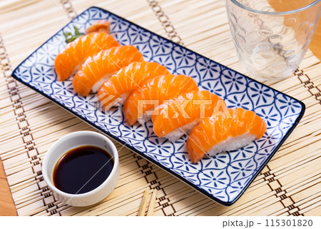 Nigiri sushi with salmon. Delicious traditional Japanese food, tasty seafood, restaurant concept 115301820