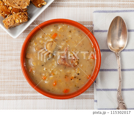 Homemade soup with mushrooms, pork, vegetables and pearl barley Homemade soup with mushrooms, pork, vegetables and pearl barley 115302017