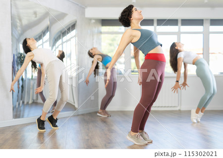 Female teacher conducts modern dance lessons for group of girls Female teacher conducts modern dance lessons for group of girls 115302021