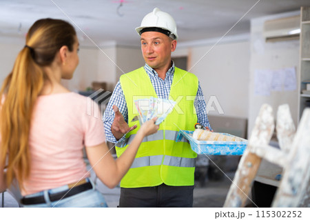 Man builder receiving money from woman employer 115302252