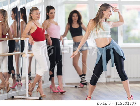 Visitors to choreographic class, observe professional rendering of dance elements performances couch 115302537