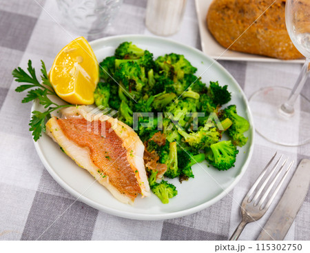 Appetising roasted rockfish fillet with seared broccoli 115302750