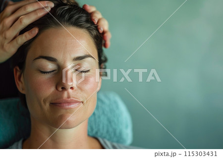 Radiant Beauty: A Woman's Wet Face in Warm Ambient Light 115303431