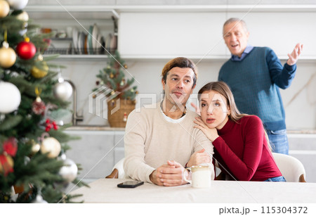 Elderly man quarreling with man and woman couple Elderly man quarreling with man and woman couple 115304372