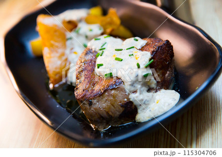 Veal sirloin with baked potato and mushroom sauce Veal sirloin with baked potato and mushroom sauce 115304706