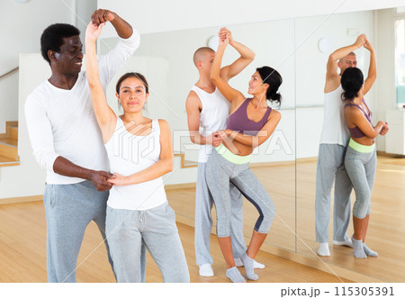 Young couples practicing active dance in pair Young couples practicing active dance in pair 115305391