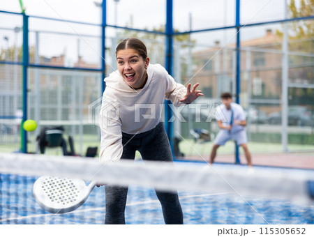 Young sporty woman playing paddle tennis outdoors Young sporty woman playing paddle tennis outdoors 115305652