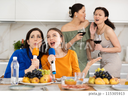 Group of women friends singing karaoke 115305913