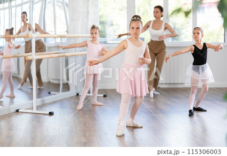 Girls in ballet class perform Batman with correction of female mentor Girls in ballet class perform Batman with correction of female mentor 115306003