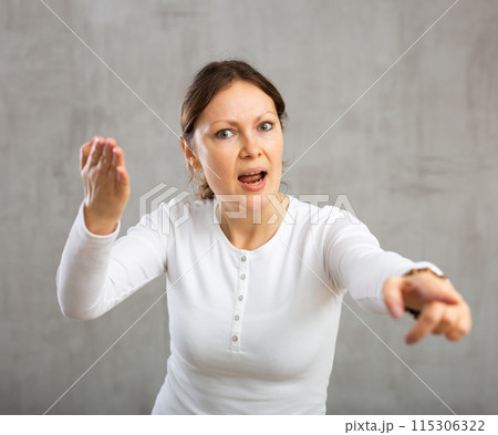 Indignant adult woman girl gesturing in studio 115306322