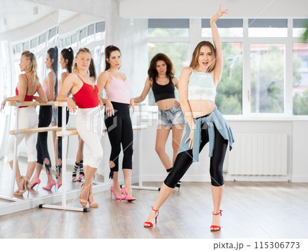 Female dancer performing solo high heels dance in studio 115306773