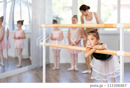 Girl dancer resting at ballet barre Girl dancer resting at ballet barre 115306867