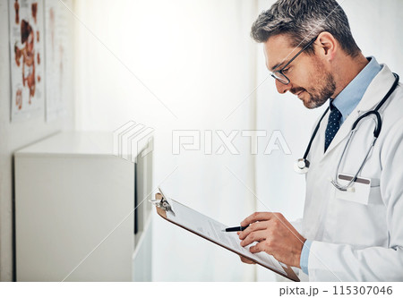 Clipboard, office and doctor reading chart with healthcare, admin and checking results at clinic. Reading, paperwork and medical professional man with schedule, report or health insurance application Clipboard, office and doctor reading chart with healthcare, admin and checking results at clinic. Reading, paperwork and medical professional man with schedule, report or health insurance application 115307046