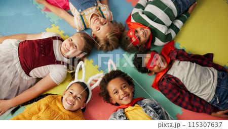 Happy children, friends and costume in class above on floor for dress up or casual day at school. Top view, portrait or young kids with cosplay outfit, hero or fairy tale in halloween classroom Happy children, friends and costume in class above on floor for dress up or casual day at school. Top view, portrait or young kids with cosplay outfit, hero or fairy tale in halloween classroom 115307637