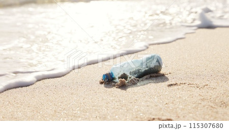 Beach, ocean and plastic bottle in sand for pollution, litter and trash in sea for global warming crisis. Nature, climate change and closeup of garbage in sea to reduce waste, recycling and cleaning Beach, ocean and plastic bottle in sand for pollution, litter and trash in sea for global warming crisis. Nature, climate change and closeup of garbage in sea to reduce waste, recycling and cleaning 115307680