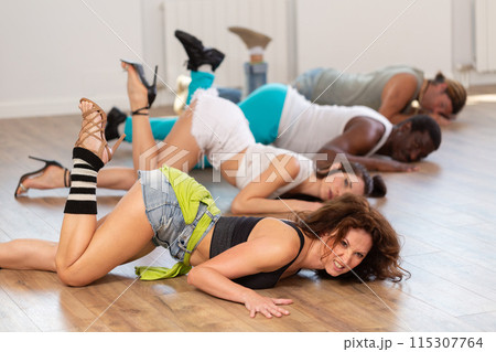 Women in heels dancing on floor in studio 115307764