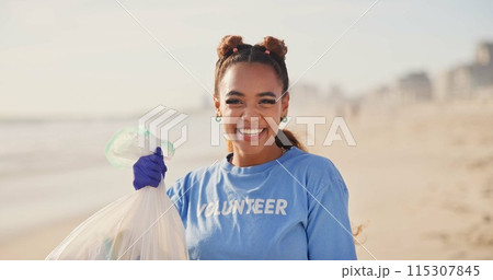 Woman, volunteer and face on beach with plastic bag for cleaning garbage, community service or sustainability. Female person, smile and trash recycling for climate change, planet or waste management Woman, volunteer and face on beach with plastic bag for cleaning garbage, community service or sustainability. Female person, smile and trash recycling for climate change, planet or waste management 115307845