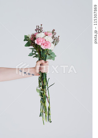 Woman, pink and flowers in hand for love with anniversary present and floral product for hope in studio. Leaves, girl manicure and holding carnation bouquet for romance and gift by white background 115307869