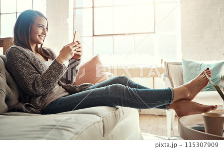 Relax, smile and woman with phone on sofa at home for social media, communication and notification. Happy, person and thinking with tech in living room for internet, connection and online dating app 115307909