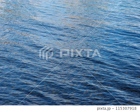Ocean Water ripples off the coast of Oahu reflecting light 115307918