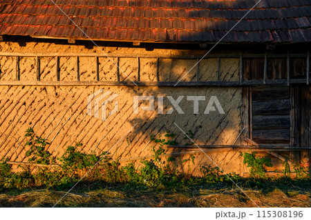 Old rural Ukrainian wooden-clay house with tiled roof 115308196
