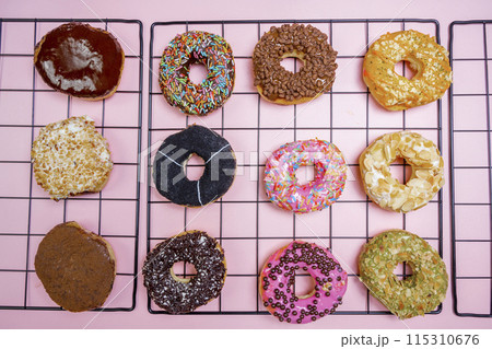 Various delicious donuts with different sprinkled decorations 115310676