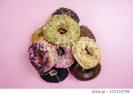 Various delicious donuts with different sprinkled decorations 115310706