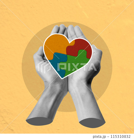 A hand holding a puzzle piece heart A hand holding a puzzle piece heart 115310832