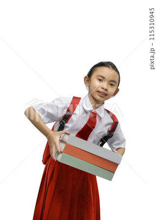Portrait of an Asian elementary school student girl in uniform with a backpack standing while carrying a stack of books Portrait of an Asian elementary school student girl in uniform with a backpack standing while carrying a stack of books 115310945