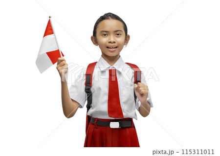 Portrait of an Asian elementary school student girl in uniform with a backpack holding a small flag of Indonesia Portrait of an Asian elementary school student girl in uniform with a backpack holding a small flag of Indonesia 115311011
