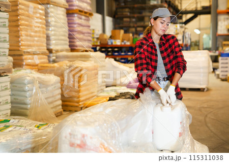 Young woman working in construction material storage Young woman working in construction material storage 115311038