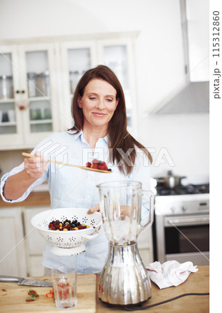 Blender, kitchen and woman with fruit for smoothie, healthy food, vegan diet and nutrition for wellness. Smile, female person and appliance for berry drink with protein and organic breakfast in home Blender, kitchen and woman with fruit for smoothie, healthy food, vegan diet and nutrition for wellness. Smile, female person and appliance for berry drink with protein and organic breakfast in home 115312860