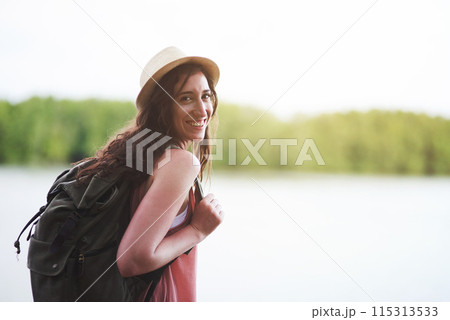 Hiking woman, portrait and smile for outdoor adventure, summer and explore woods with backpack, excited and happy face. Girl, forest and travel for walk, nature vacation and holiday for exploring 115313533