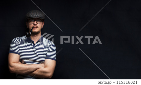 Muscular sailor with crossed arms in a close-up portrait. Banner for design with copy space. Concept of masculinity. Black background Muscular sailor with crossed arms in a close-up portrait. Banner for design with copy space. Concept of masculinity. Black background 115316021