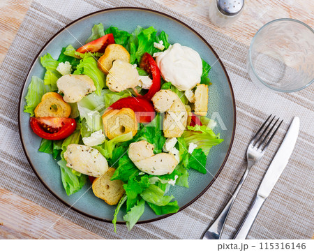 Portion of fresh Caesar salad with tomatoes Portion of fresh Caesar salad with tomatoes 115316146