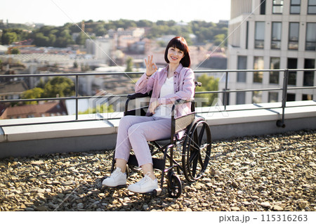 Woman in wheelchair smiling outdoors on sunny day Woman in wheelchair smiling outdoors on sunny day 115316263
