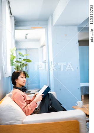 音楽を聴きながら読書をする女性/リスキリング 115316782