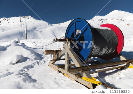 Power cable on reels. Thick electrical wire. Wire spools for outdoor use. Electrical products at a ski resort en street in the snow 115316820