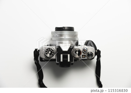 modern camera in retro style with a strap close-up, top view 115316830