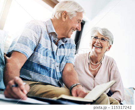 Writing, notebook and senior couple in home planning for retirement fund, savings and pension. Smile, investment and elderly man and woman with budget notes for bills, mortgage and debt payment. 115317242