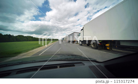 A jam of vans on the roads of Europe. View from the car window. A jam of vans on the roads of Europe. View from the car window. 115317274