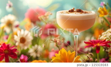 Cocktail glass of a creamy beverage with a hint of cinnamon, vibrant summer flower garden backdrop 115319163